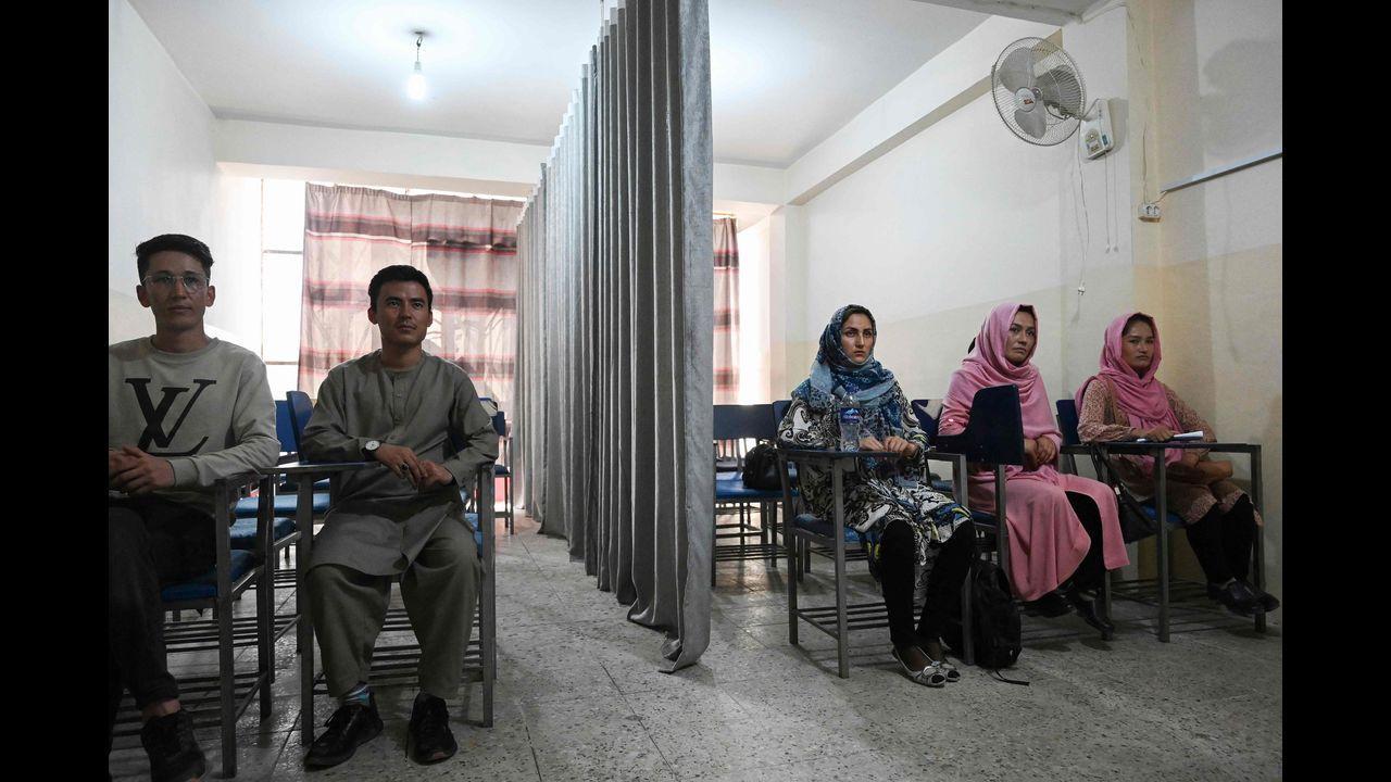 Students attend a class bifurcated by a curtain separating males and females at a private university in Kabul. Pic/AFP